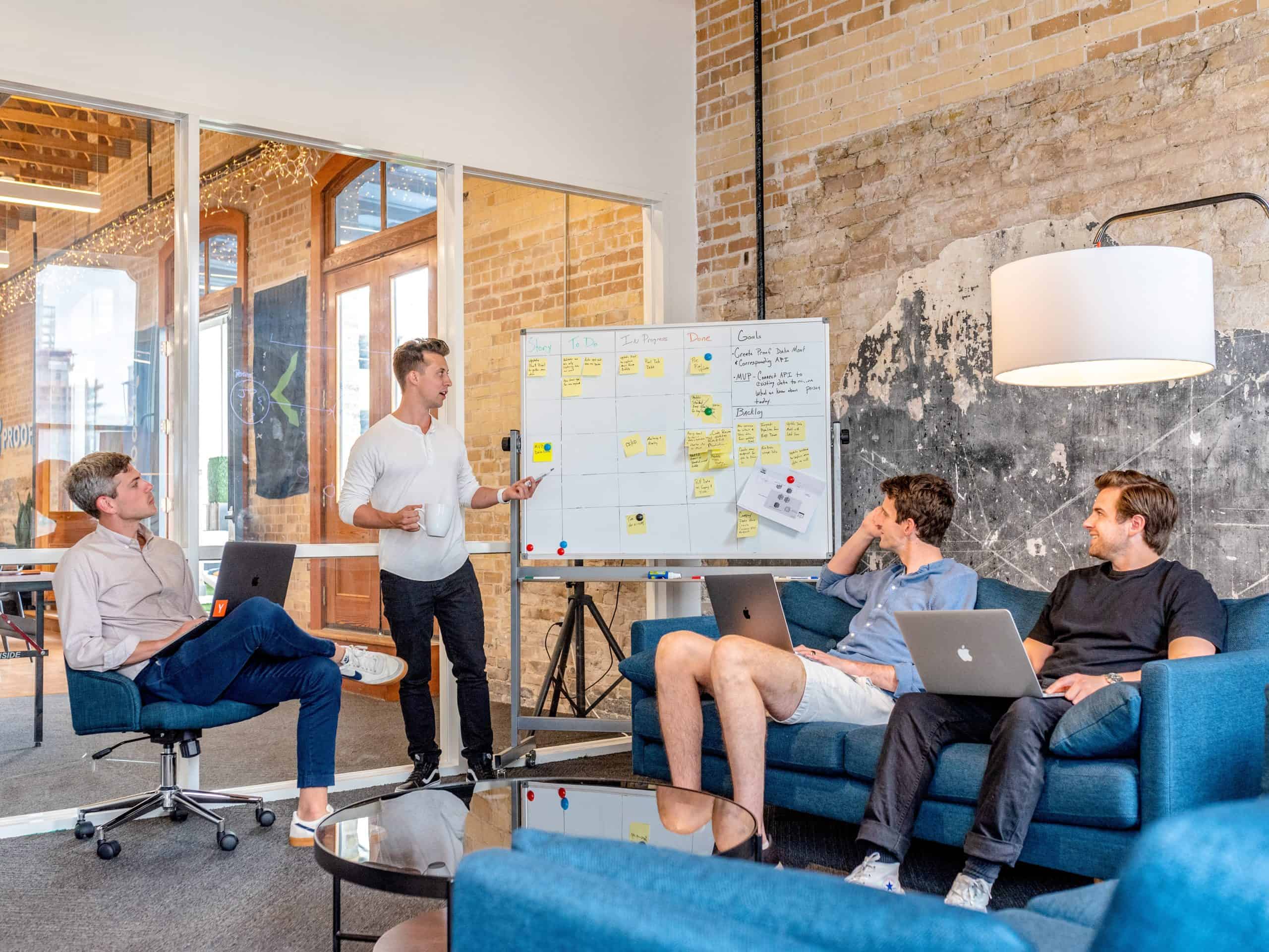 4 software team members working on a consulting project on a whiteboard