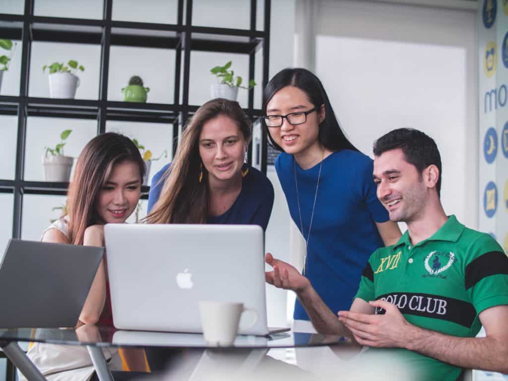 diverse group of software developers working on a laptop